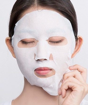 woman using a sheet mask